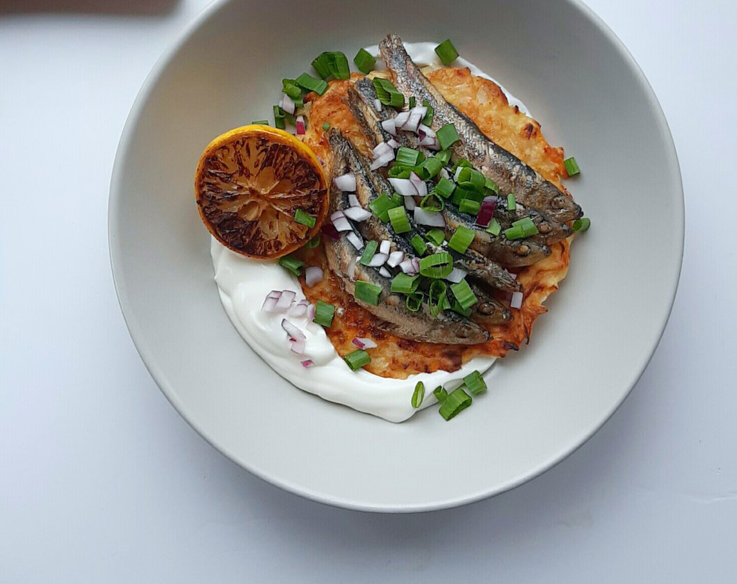 Sprats with sauerkraut pie with homemade cream, red and spring onions