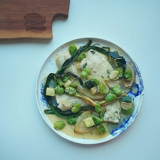 Wine-braised Baltic turbot with broad beans, courgettes, fried chives and sweet onions